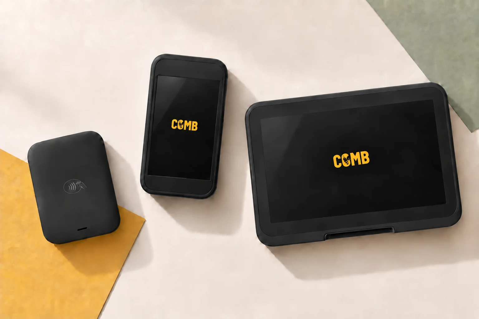Illustrative overhead lineup of Comb Go, Flex, and Studio on cream paper with yellow and sage accents. Only the two touchscreen devices display the Comb logo.